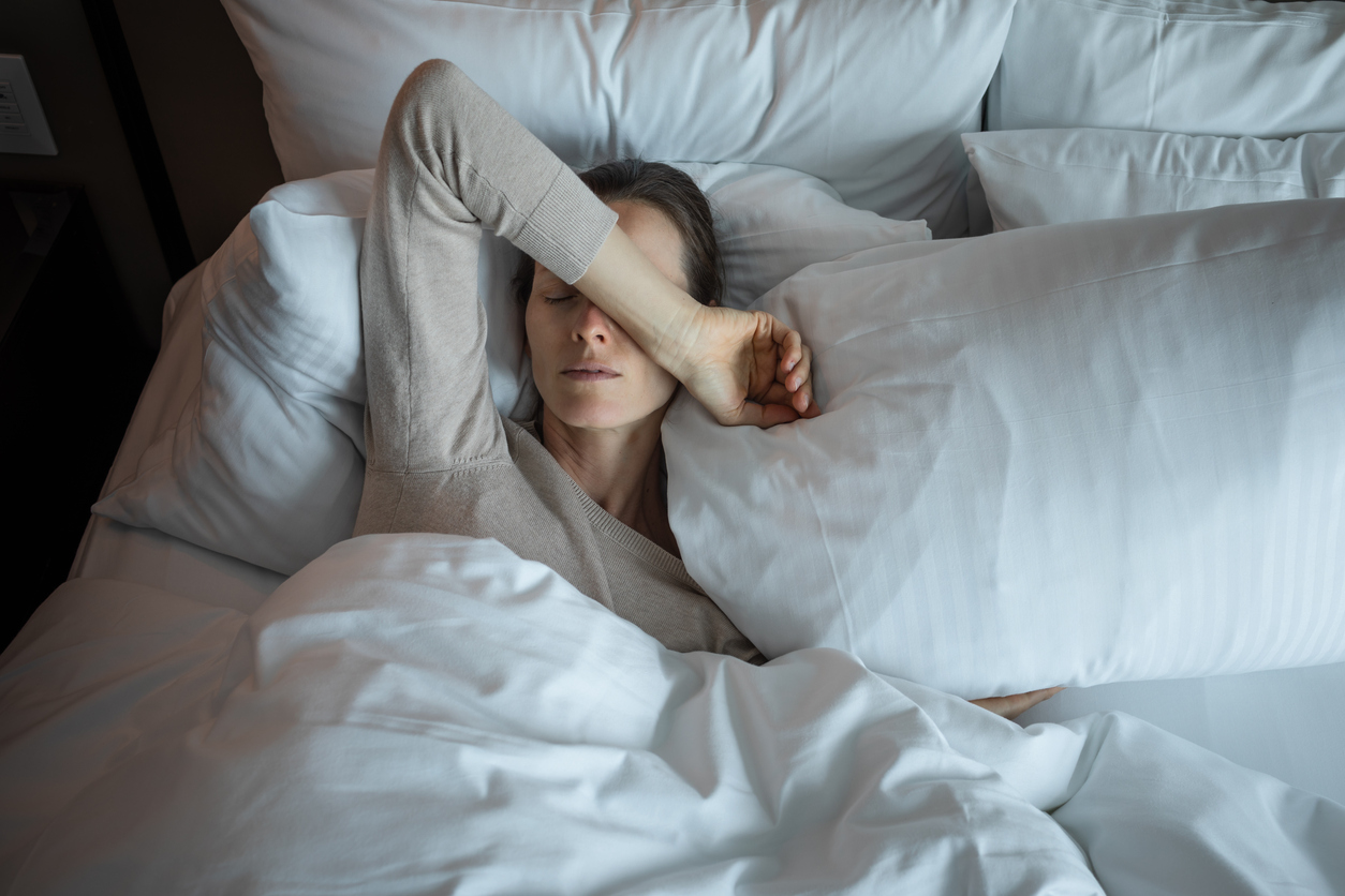 Young woman waking up and feeling tired (suffering from fatique.)
